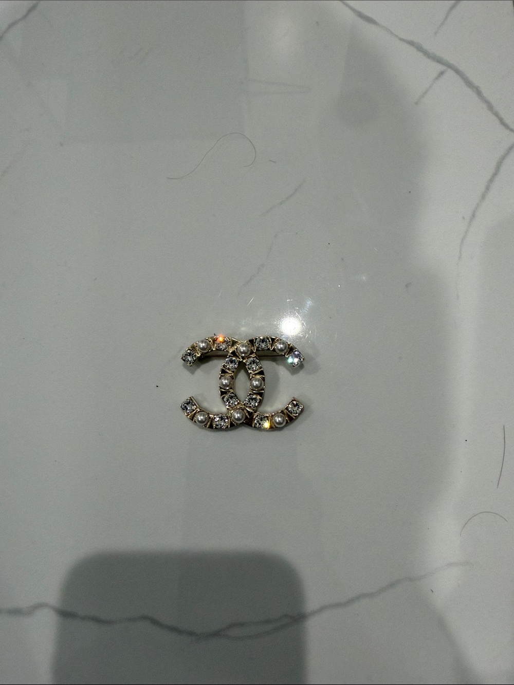 CHANEL Crystal-Embellished Double C Brooch in Gold and Clear